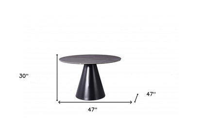 Sloane 47-inch round dining table with a grey stone top on an iron pedestal base, additional view