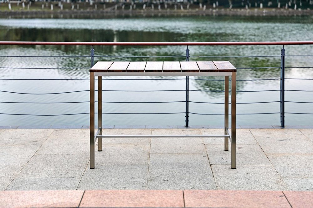 Ellis 55-inch dining table with a brown solid wood top on a silver stainless steel base, additional view