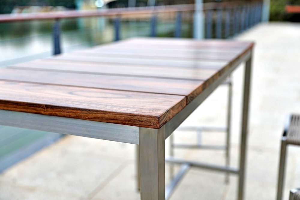 Ellis 55-inch dining table with a brown solid wood top on a silver stainless steel base, additional view