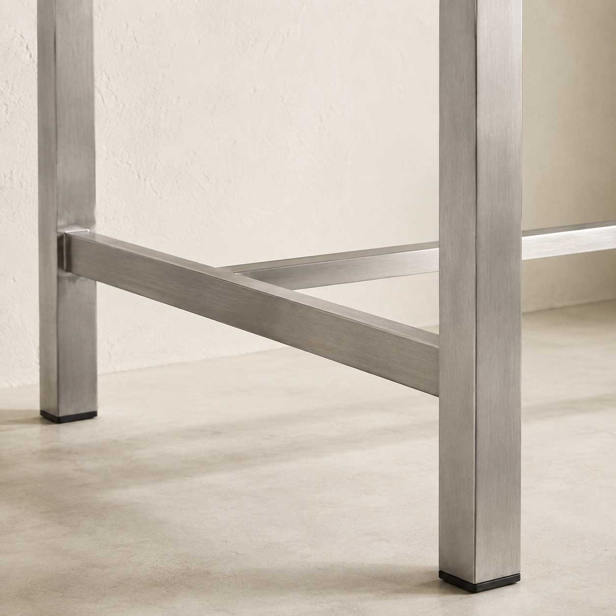 Ellis 55-inch dining table with a brown solid wood top on a silver stainless steel base